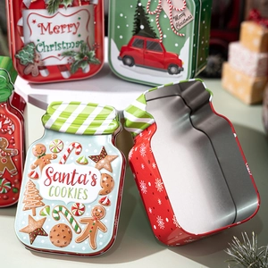 Detailed macro view of open Christmas tin boxes with festive gingerbread and Santa designs