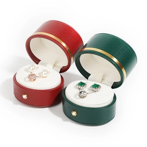Red and green PU leather jewelry boxes with white velvet lining and gold metal trim