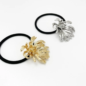 Irregular metal flower hair ties in gold and silver finish with elastic black bands