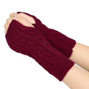 Close-up of deep wine red cable-knit fingerless gloves with detailed textured arm warmers