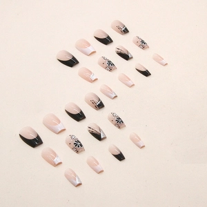 French style black and white press-on nails with floral patterns and silver glitter accents