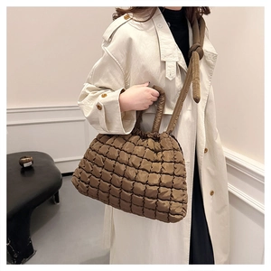 Brown quilted tote bag showing high-capacity texture and soft padded fabric details