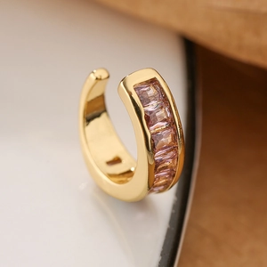 Macro shot of 18K gold plated ear cuff with baguette-cut pink zircon stones