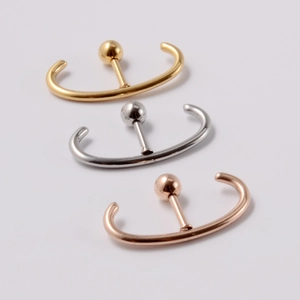 Detailed view of U-shaped surgical steel cartilage studs in gold silver and rose gold