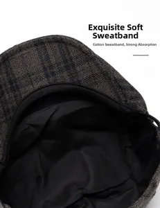 Detailed macro view of soft cotton sweatband inside the dark plaid wool flat cap