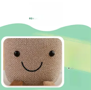 Detailed view of plush red palm plant toy featuring burlap texture and embroidered face