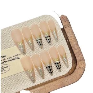Handmade stiletto press-on nails with nude matte base and golden metallic chic lines