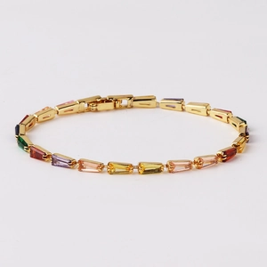 Macro detail of rainbow tennis bracelet with multi-color cubic zirconia in gold setting