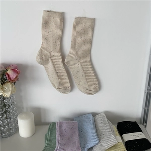 Detailed close-up of colorful speckled cotton crew socks set with diverse pastel colors