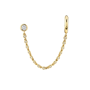 Macro view of gold chain earrings with sparkling zircons and stud connector details