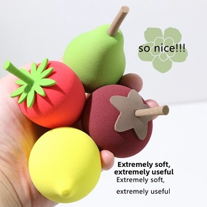 Macro shot of fruit-shaped makeup sponges showing strawberry and lemon textures