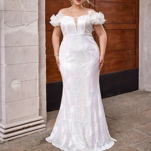Detail of white sequin fishtail dress with ruffled sleeves and mesh bodice insert