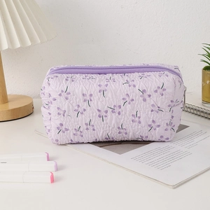 Detail of lavender floral pencil case featuring pleated fabric texture and zipper closure