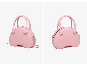 Detail view of pink PVC jelly bag showing metal chain strap and top handle finish