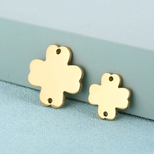 Golden stainless steel symmetrical clover pendants on a light blue background for jewelry DIY