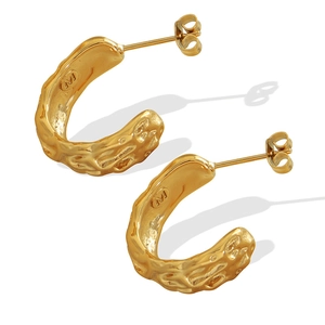 Elegant 18K gold-plated C-shaped earrings with vintage lava texture on white background