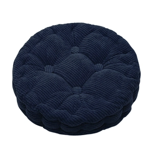 Close-up of deep blue round corduroy seat cushion with five quilted button details