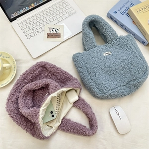Detail of plush fleece handbags in blue and purple showing soft texture and inner lining