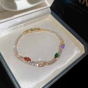 Detailed view of an 18k gold-plated double-layer bracelet with colorful cubic zirconia.