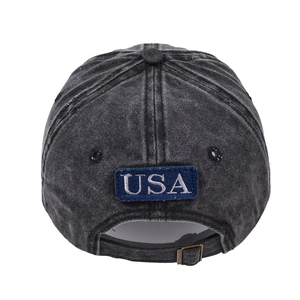 Detail of adjustable metal buckle and USA embroidery on washed black denim baseball cap