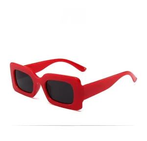 Side view of red rectangular sunglasses with dark lenses and high-gloss plastic frames
