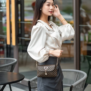 Quilted checkerboard shoulder bag with gold chain strap and cat-shaped pearl clasp