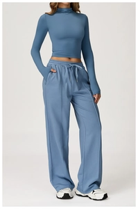 Detail of thumbhole cuffs and side pockets on a Morandi blue athletic knit tracksuit