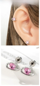 Detail of pink heart zircon stud earrings with silver star orbit design on ear model