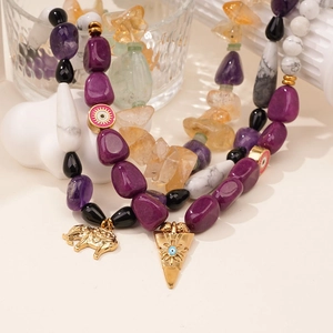 Natural gemstone necklace featuring purple amethyst beads and gold elephant eye charms