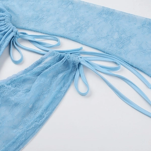 Dettaglio del tessuto in pizzo azzurro con mesh trasparente e lacci regolabili