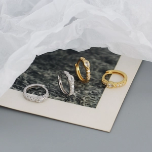 Macro shot of gold and silver S925 sterling silver earrings with pear-shaped cubic zirconia