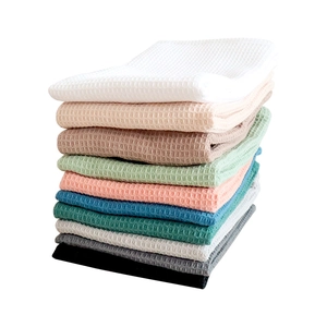 Cotton waffle weave dish cloths set in multi-color stacked arrangement for kitchen use