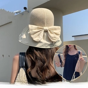 Detail of beige sun visor with a detachable bow that converts into a storage bag