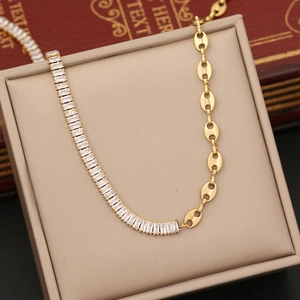Golden stainless steel pig nose chain necklace with zircon stones on a beige display box