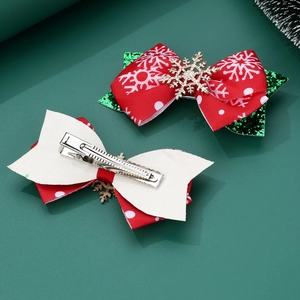 Detail of Christmas ribbon bow clips showing red sequins and metal alligator clasp