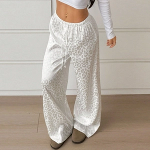 Detail of high waist white leopard print wide leg pants with drawstring elastic waist