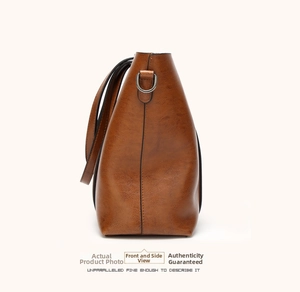 Side view of caramel brown leather bucket bag showing fine stitching and metal D-ring