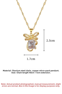 Detail view of gold titanium steel bow necklace with size dimensions and micro-pave crystals