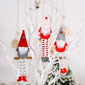 Three Christmas gnomes with long striped legs hanging on a white decorative branch