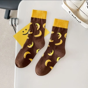 Brown cotton socks with yellow banana pattern and ribbed cuffs on a white background
