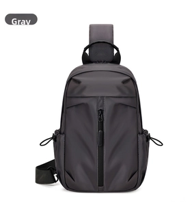 Front detail of a grey oxford cloth crossbody bag featuring drawstring side pockets