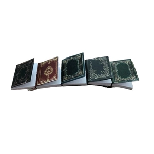 Miniature book hair clips with vintage gold foil patterns and colorful covers