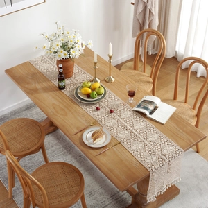 American retro floral crochet table runner with tassels in a boho dining setup