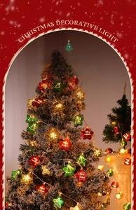 Detail of colorful star-shaped LED lights with Merry Christmas prints on a snowy tree