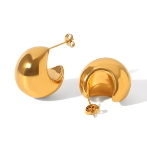 Macro view of chunky C-shaped 18K gold plated earrings with high-polish mirror finish