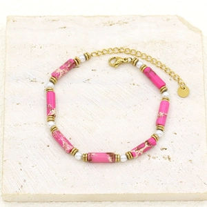 Detailed macro of pink imperial stone and pearl beaded bracelet with gold plated clasp