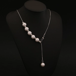 Elegant silver snake chain necklace with faux pearl pendants shown on a black bust