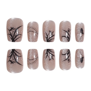 Press-on nails featuring ink flower patterns and champagne glitter in a chic oriental style