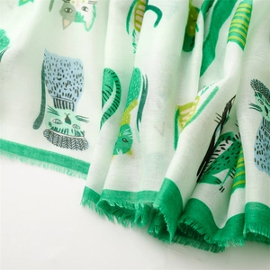 Close-up of cute green cat prints and frayed edge detail on cotton linen scarf