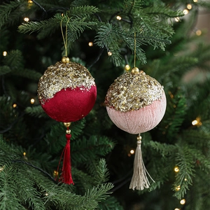 Velvet Christmas ball ornaments with gold sequins and elegant tassels on a festive tree